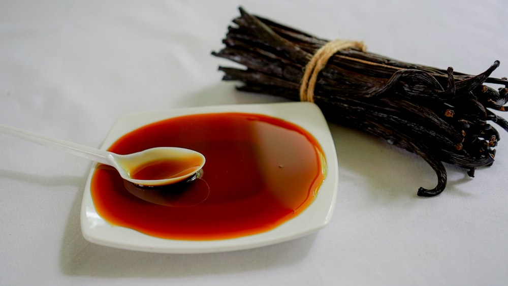 a spoon is sitting in a bowl of red liquid