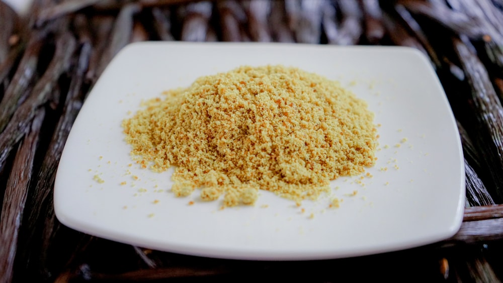 a white plate topped with a pile of food