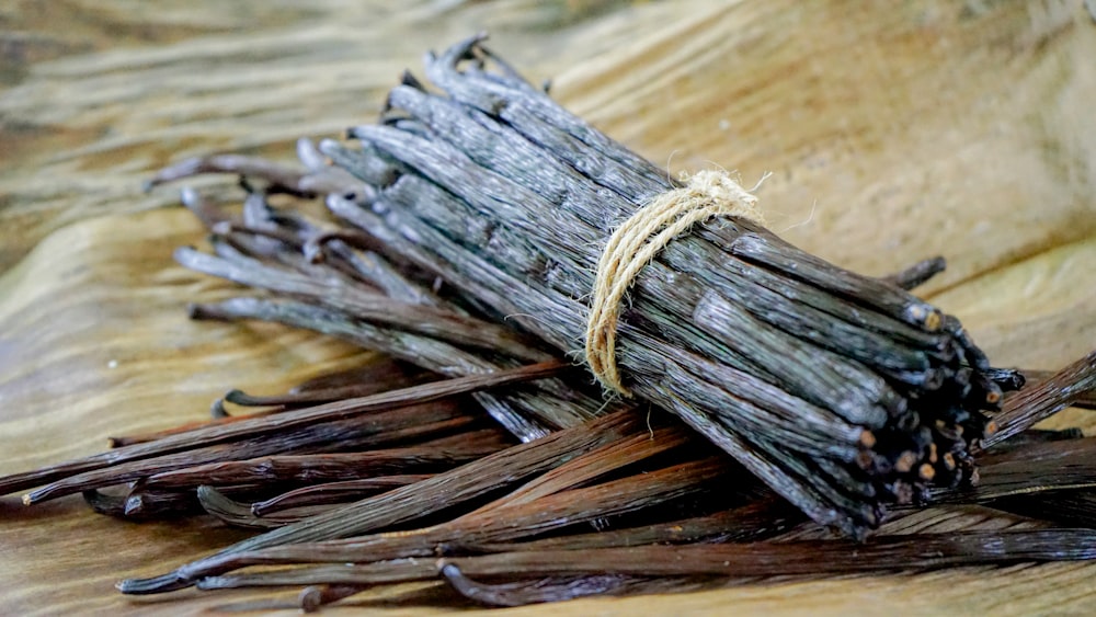 a bundle of sticks sitting on top of a wooden table