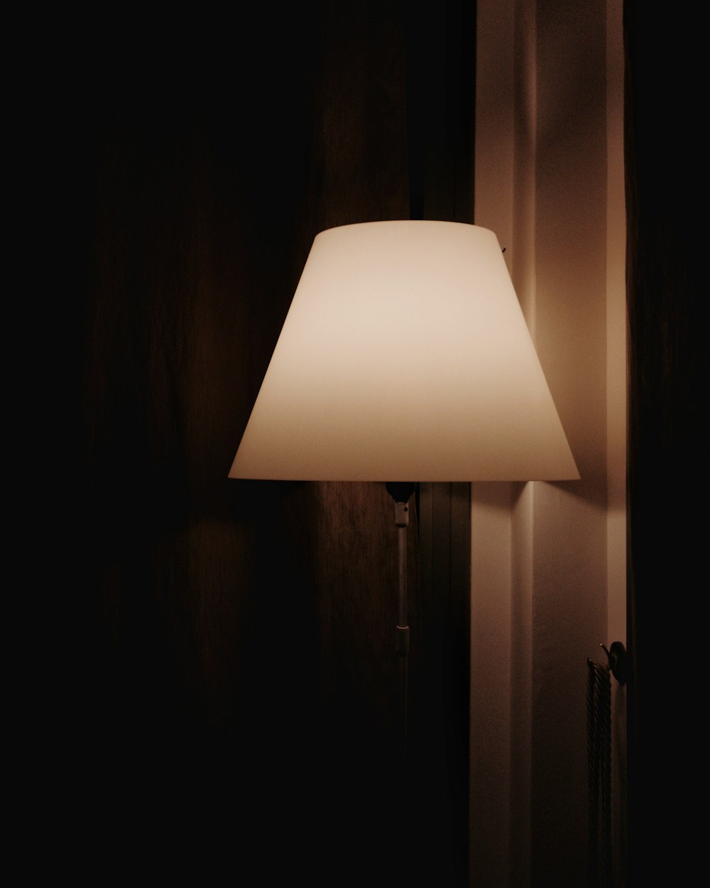 a lamp that is on a wall in a room