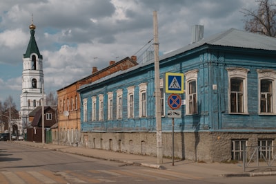 a blue building with a clock tower in the background