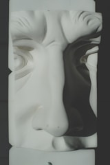 Close-up of a realistic 3D sculpted character with expressive features.
