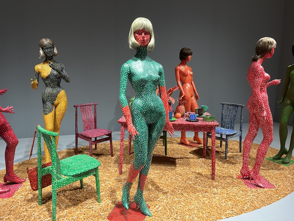 a group of mannequins standing around a table