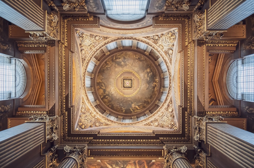 the ceiling of a building with a painting on it