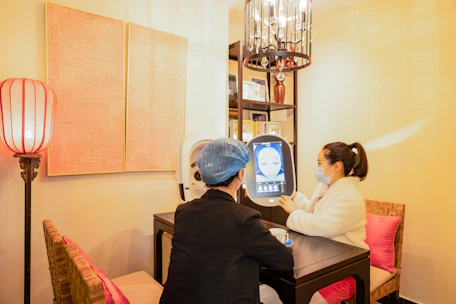 A warm, inviting virtual therapy session showing a smiling counselor and calm client on screen.