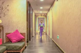 Nurse walking calmly through a peaceful, softly lit hallway in the clinic.