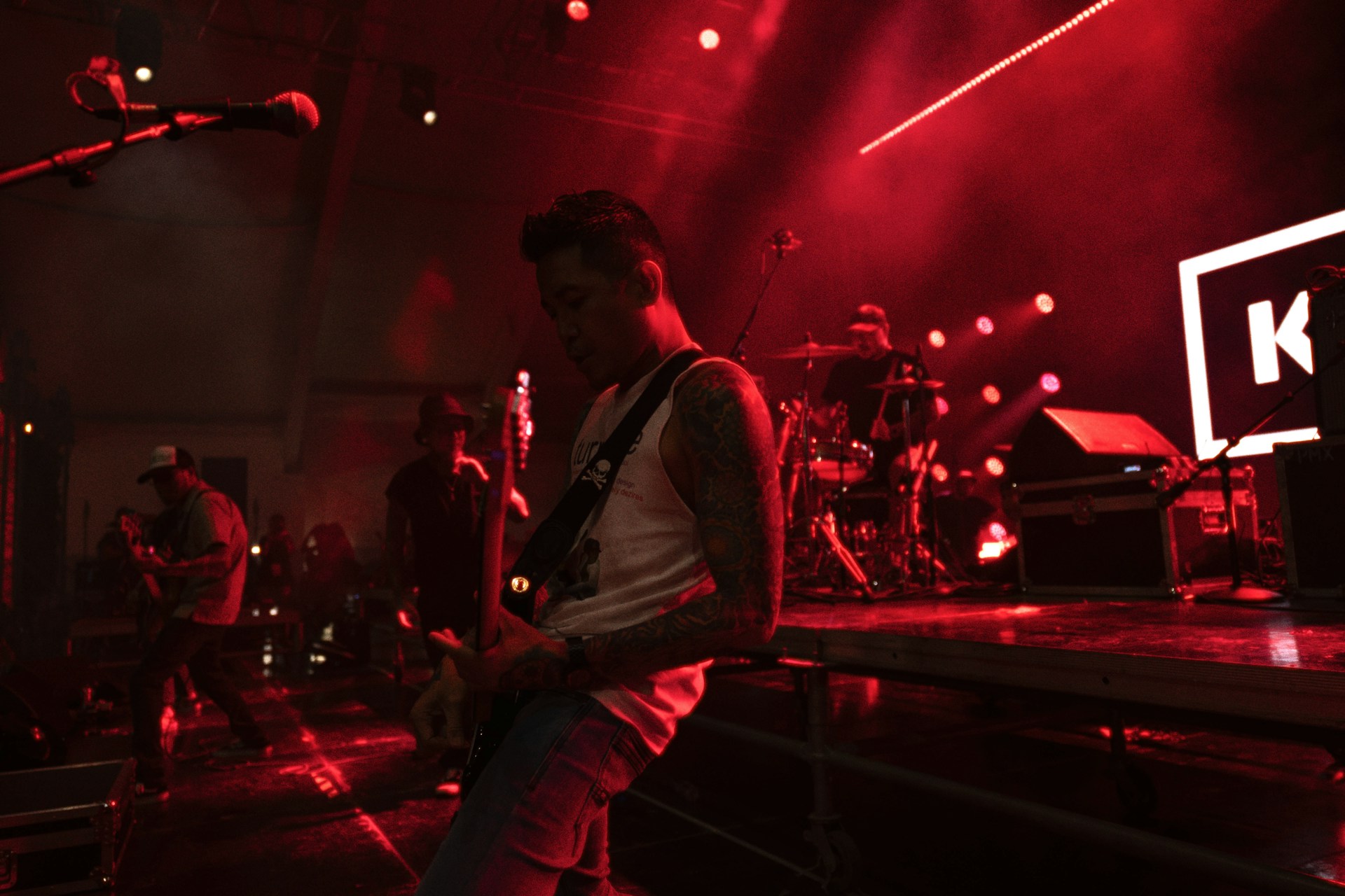 a man standing in front of a microphone on a stage