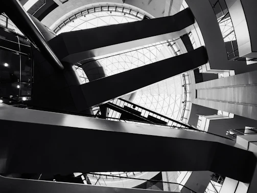 Black and white image of an architectural model highlighting sharp angles and open spaces.