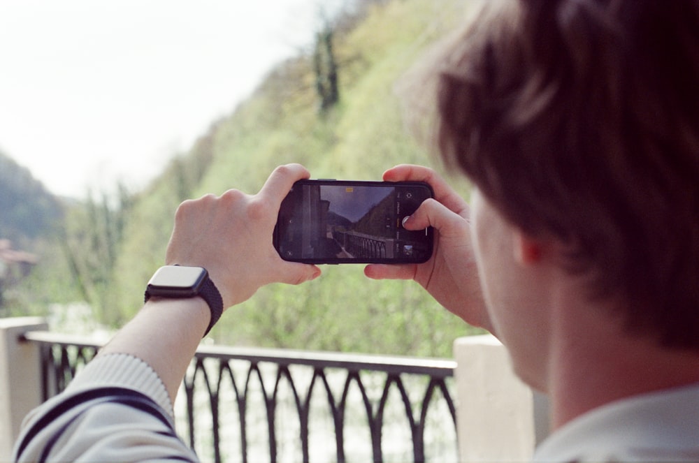 a man taking a picture with his cell phone