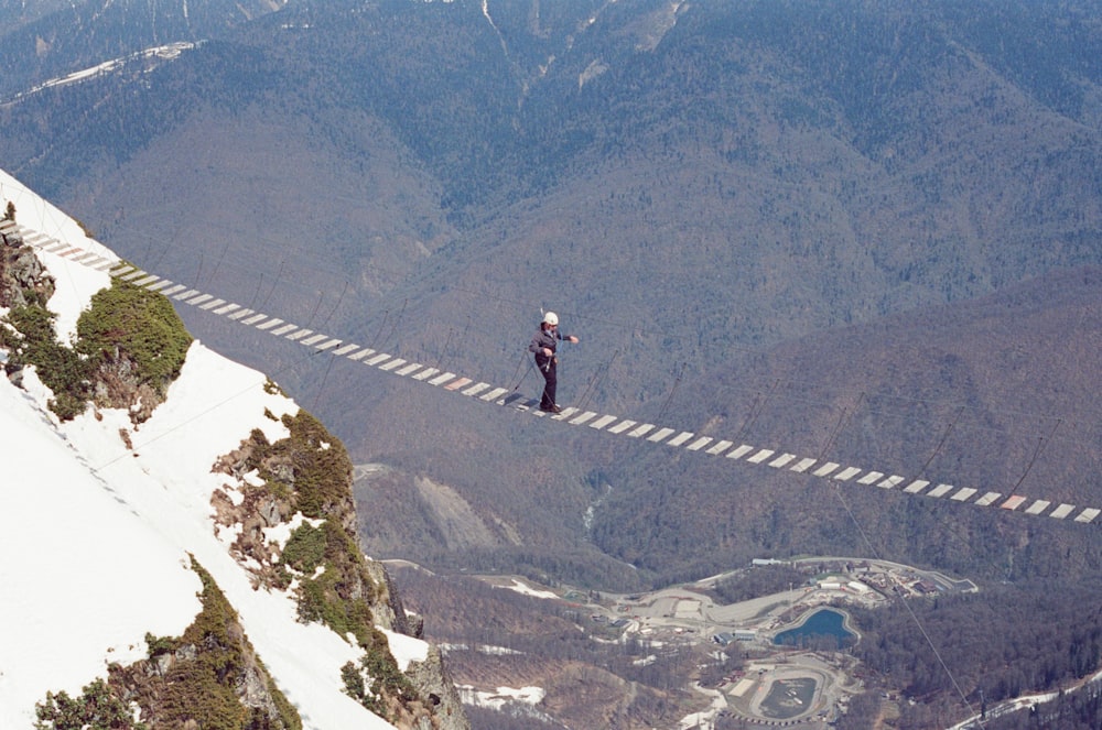 a man standing on a rope high up in the air