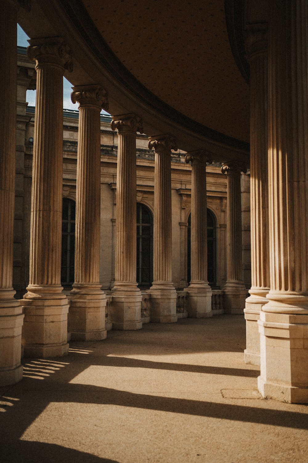 a building with columns and a clock on the wall