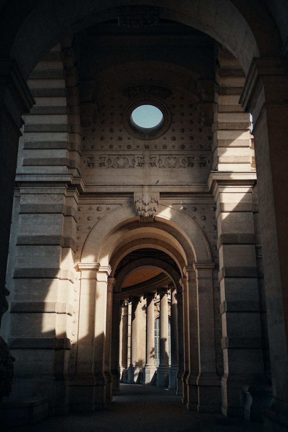 an archway with a circular window in the middle of it