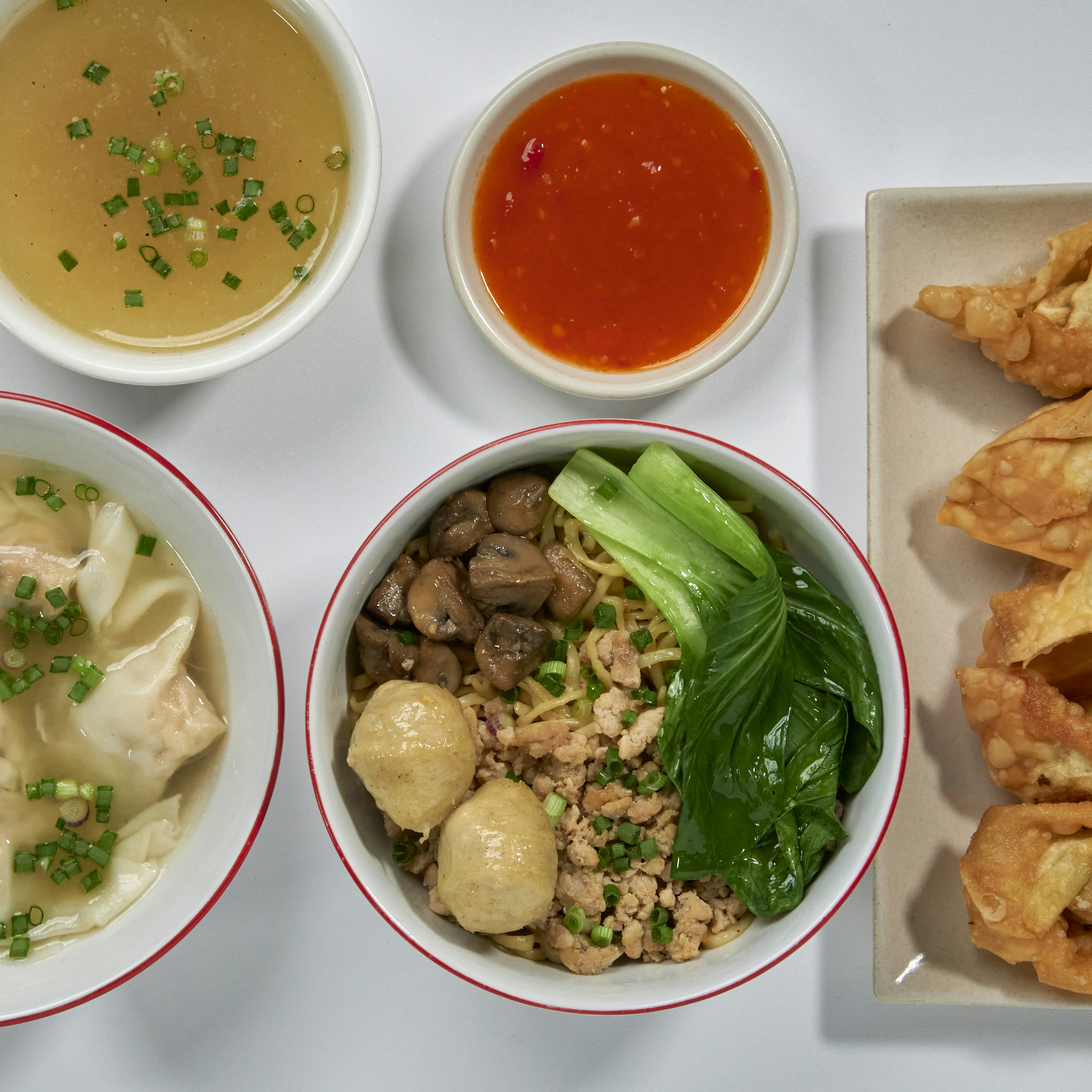 a table topped with bowls of food and bowls of soup