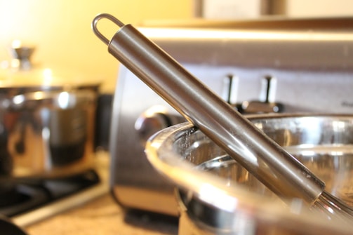 A sleek robotic whisk bot in action, mixing ingredients in a modern kitchen.