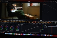 a computer screen showing a man sitting in a chair