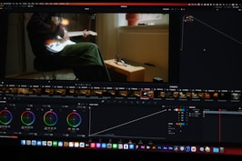 a computer screen showing a man sitting in a chair