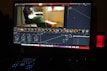 Editing suite with multiple screens showing color grading and sound waves.