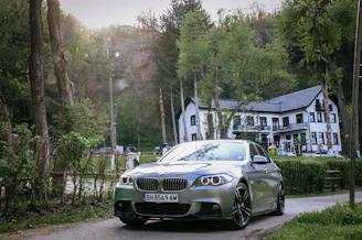 A sleek rental car parked outside Kingfisher Haven on a sunny day.