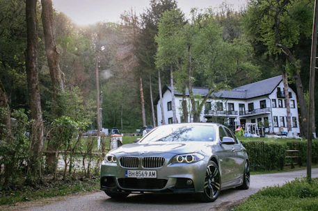 A sleek rental car parked outside Kingfisher Haven on a sunny day.