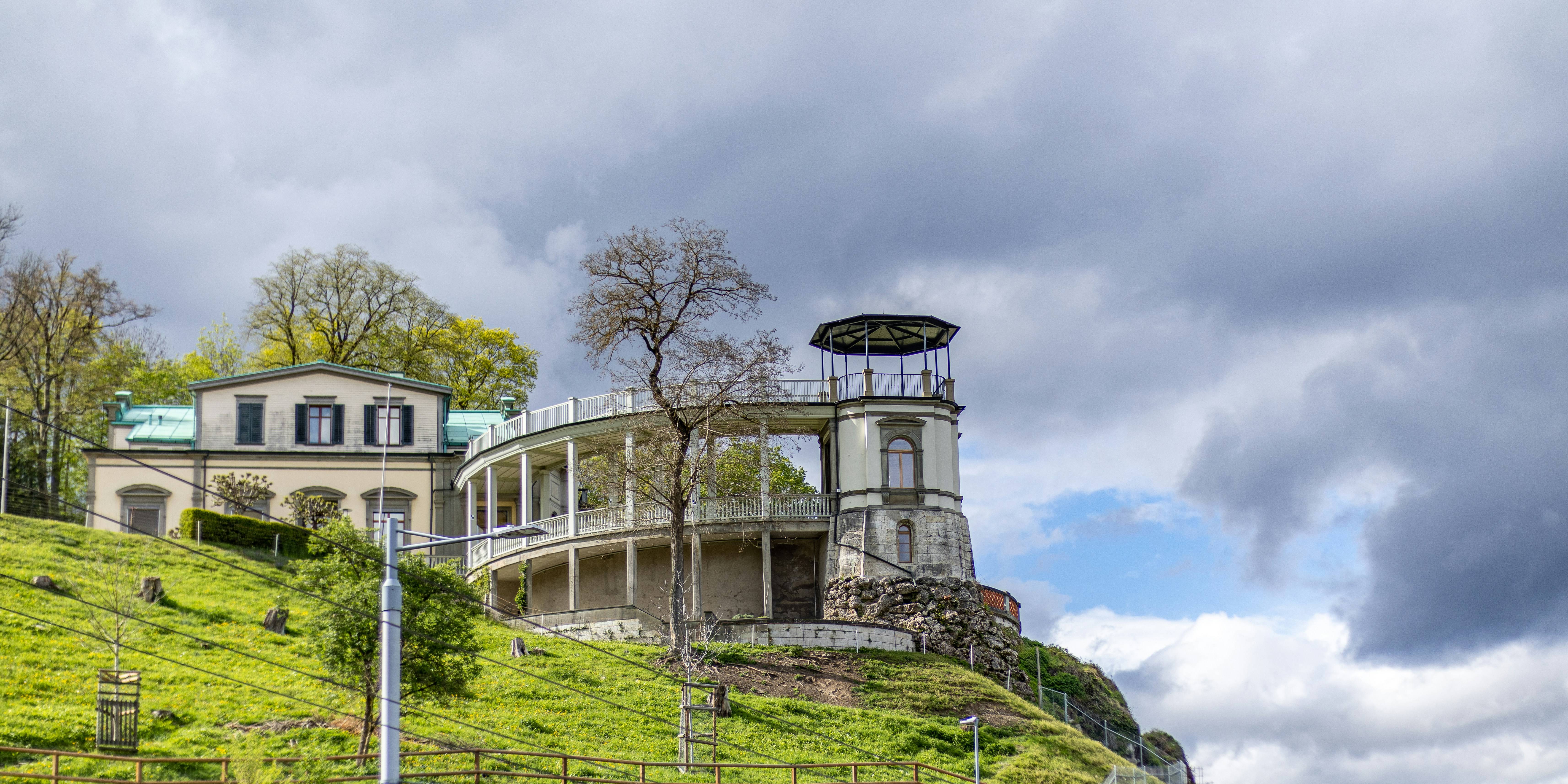 a house on a hill with a clock tower on top, 