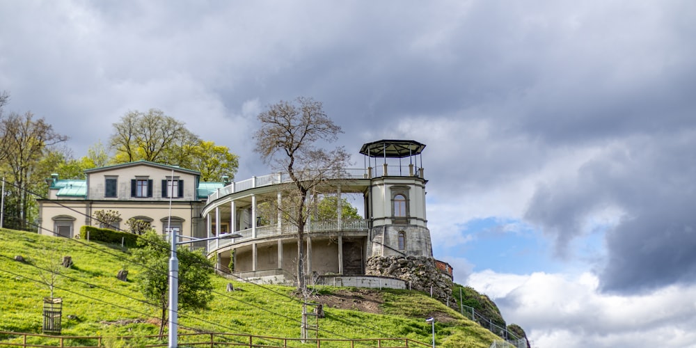 a house on a hill with a clock tower on top