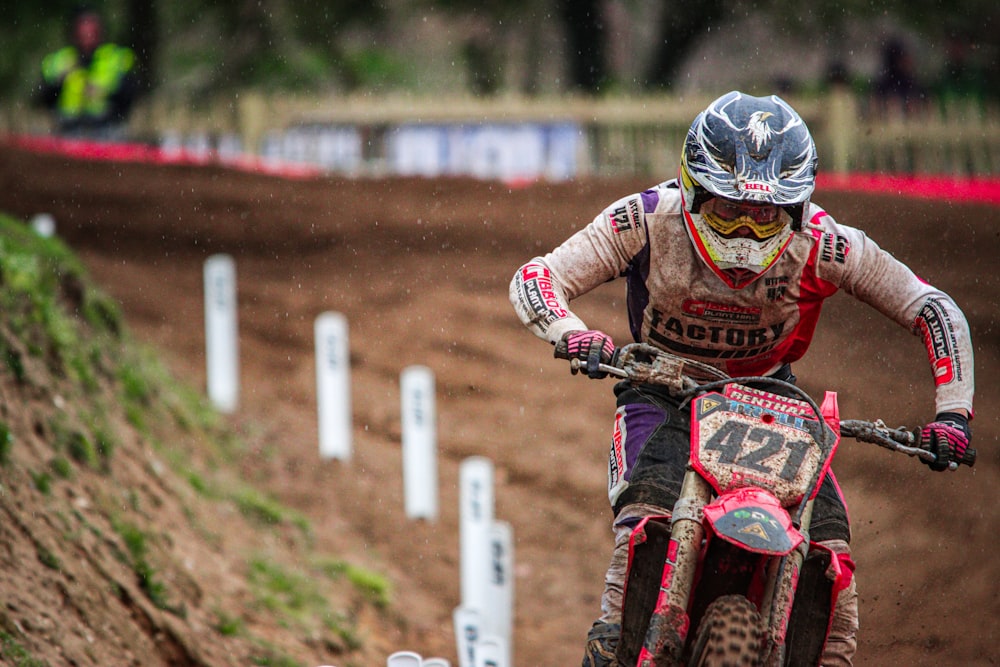 a person riding a dirt bike on a dirt track