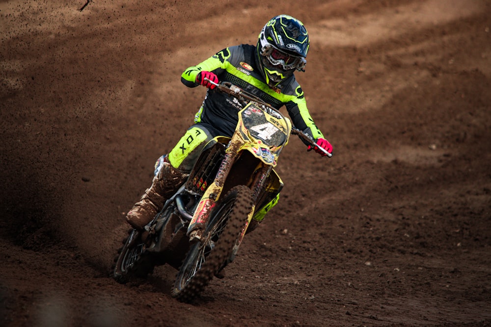 a man riding a dirt bike on top of a dirt field