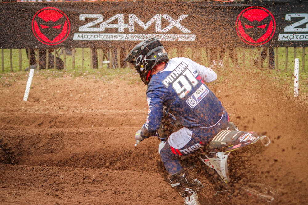 a man riding a dirt bike on top of a dirt field