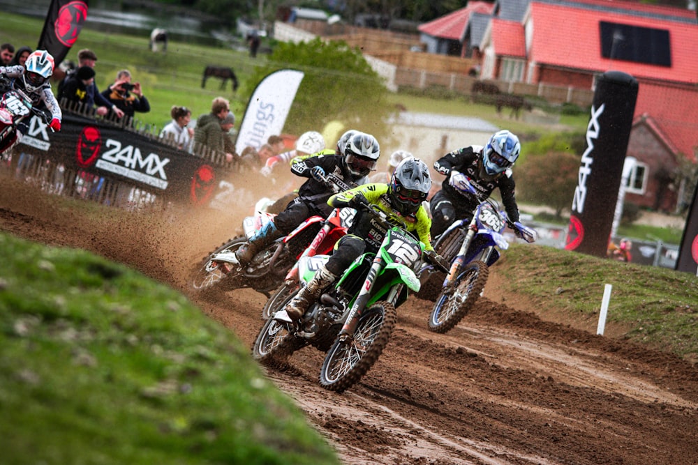 a group of people riding dirt bikes on a dirt track