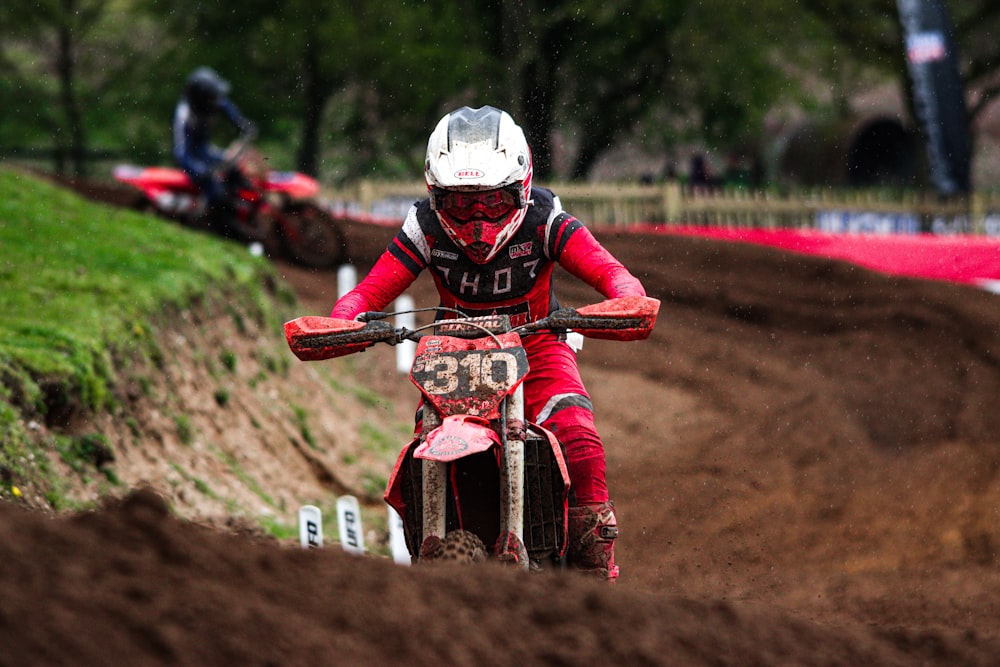 a person riding a dirt bike on a dirt track