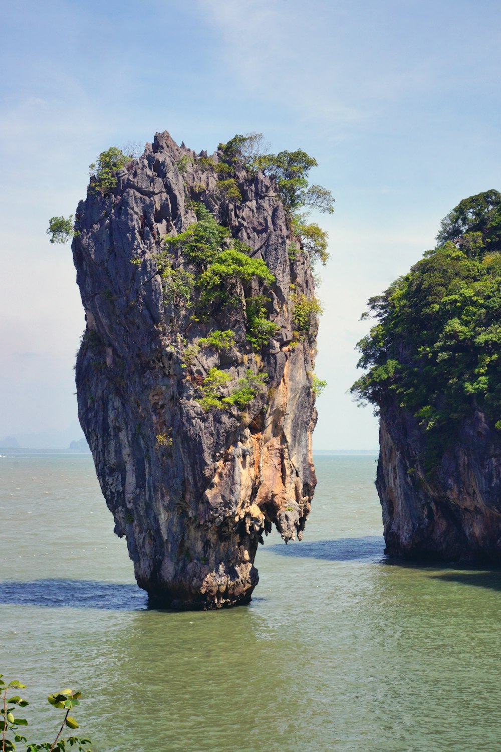 a large rock in the middle of a body of water