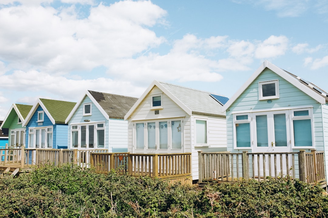 a row of beach houses sitting next to each other, Row of beach homes in Mudeford