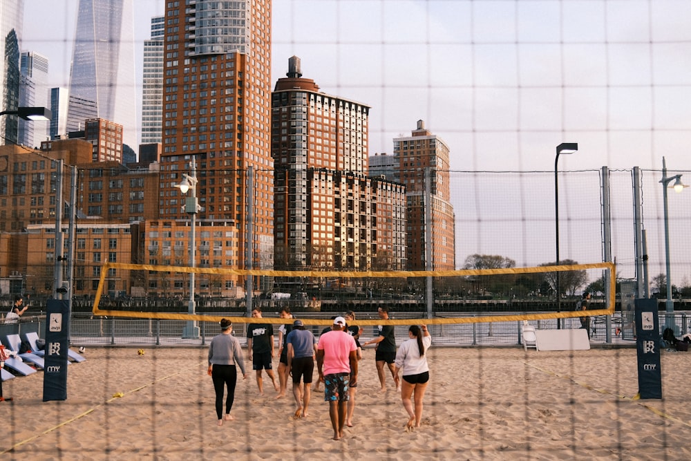 a group of people are playing volleyball on the beach