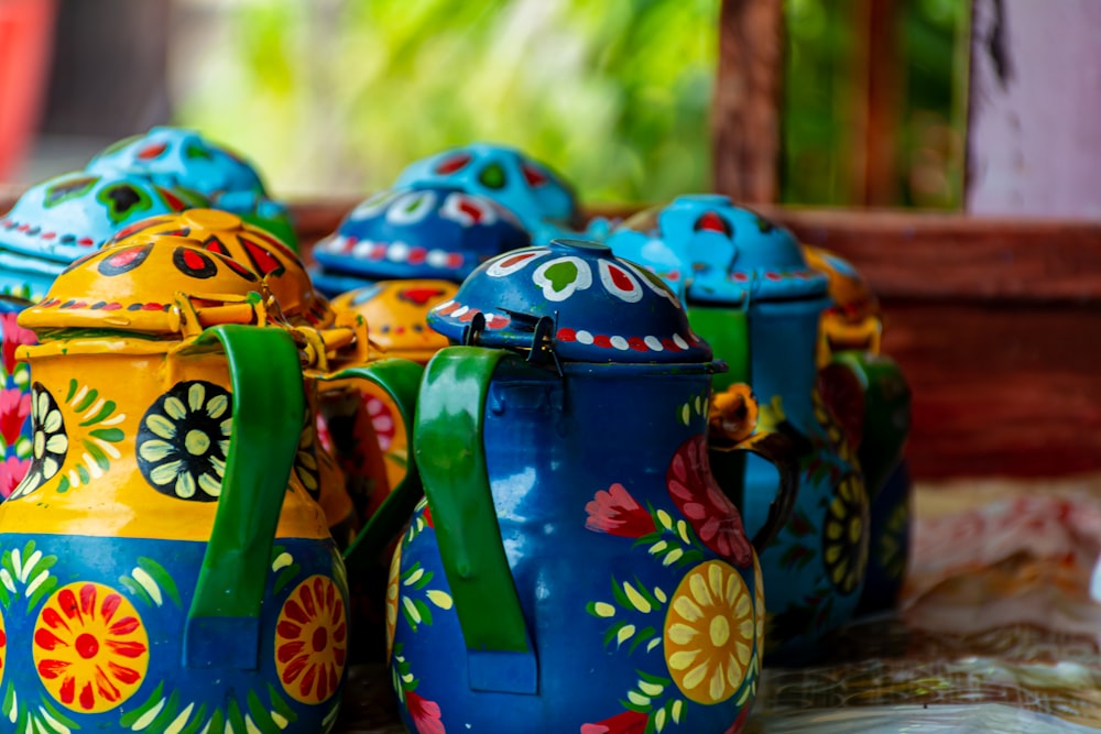a group of colorful pots sitting on top of a table