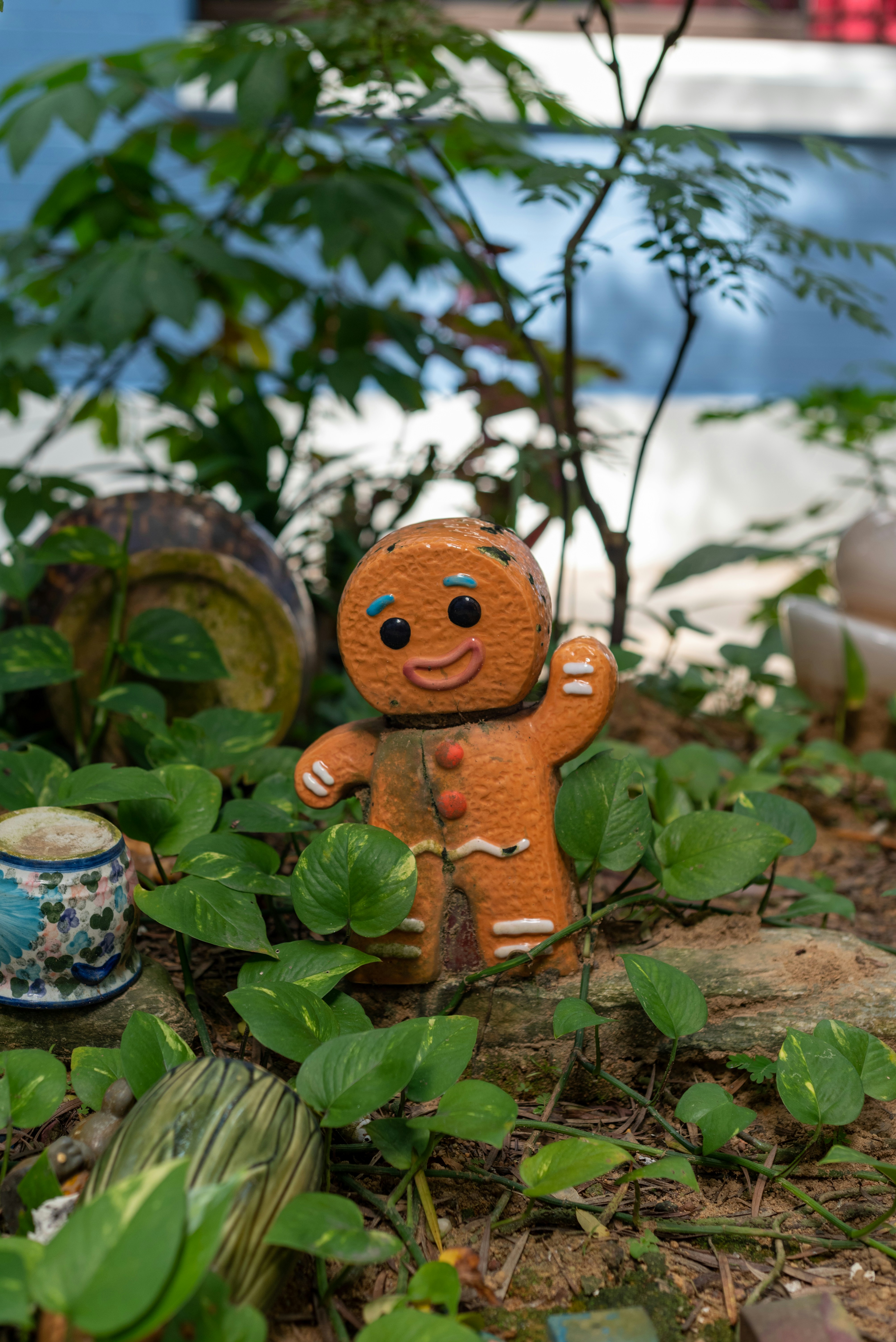 a gingerbread man figurine sitting in a garden