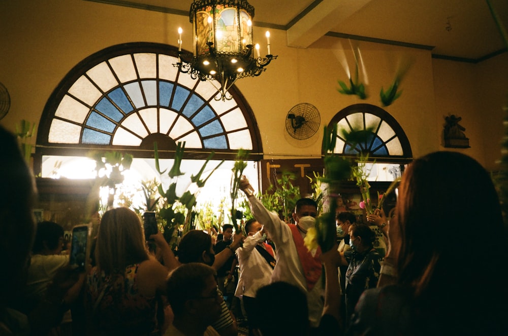 a group of people standing in front of a window