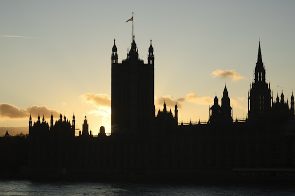 An artistic shot capturing Regal Rhythm’s silhouette framed by subtle rainbow hues and gothic architectural details.