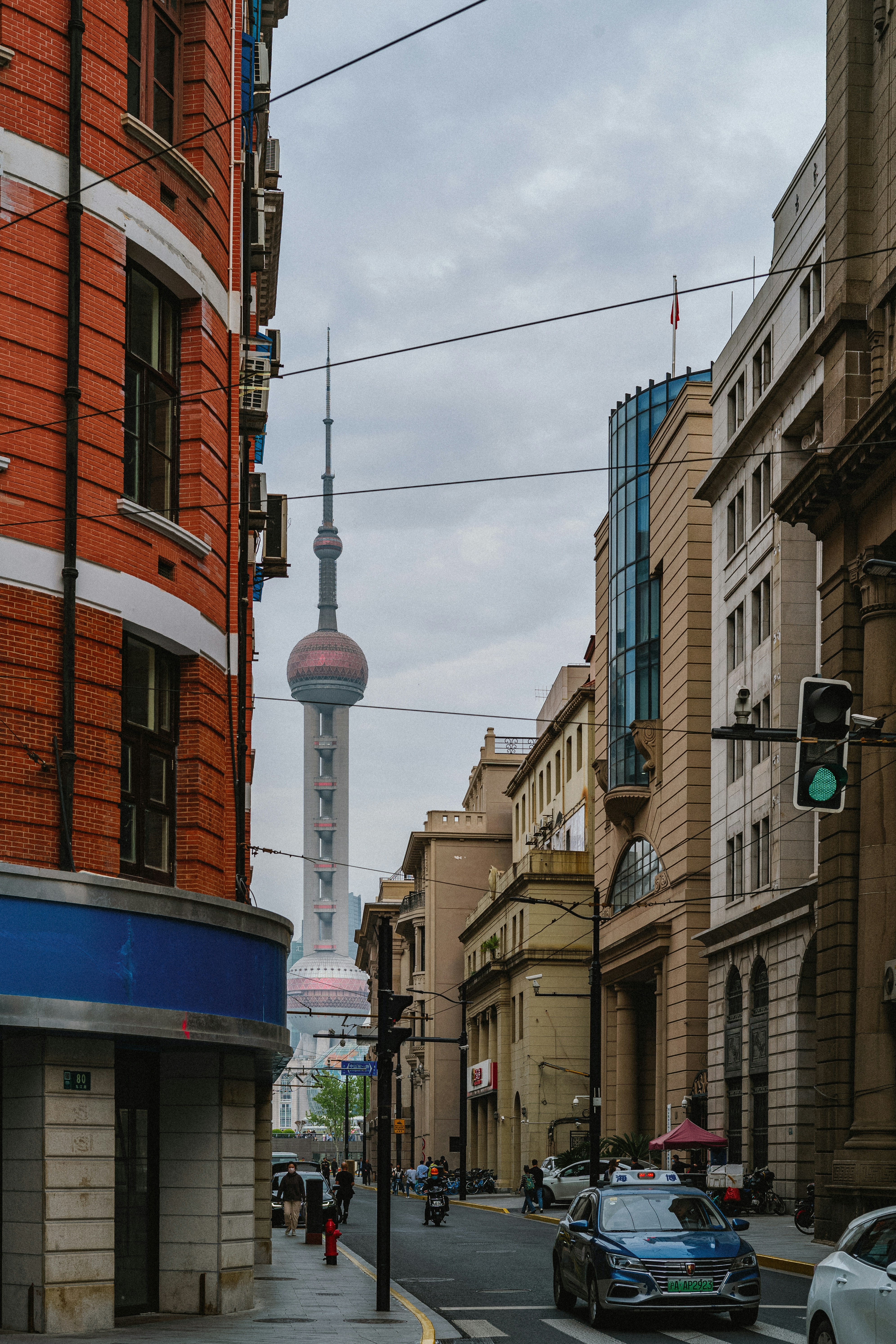 a city street with a tall building in the background