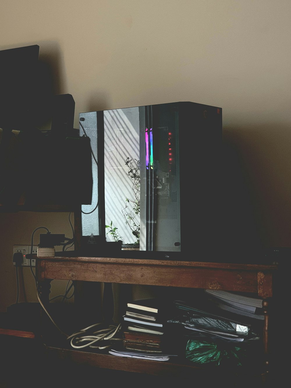a computer tower sitting on top of a wooden desk