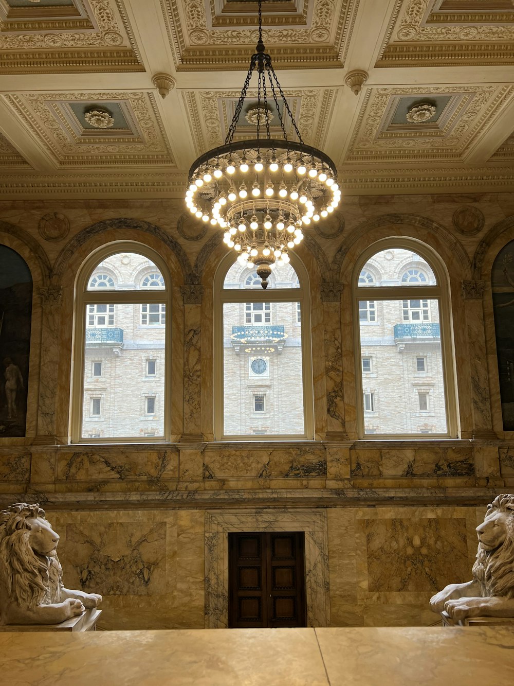 a chandelier hangs from the ceiling in a large room