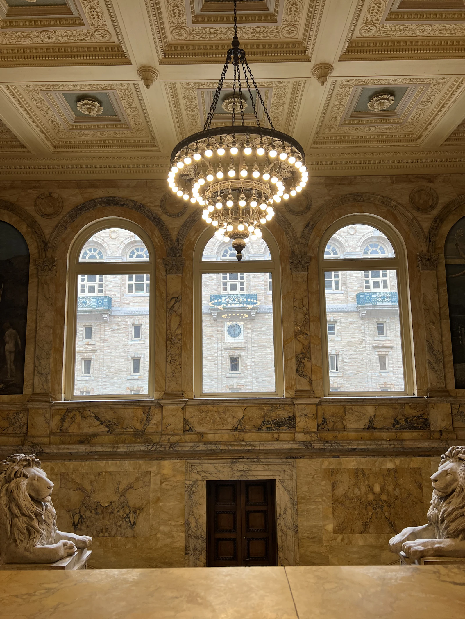 A chandelier hanging from the ceiling in a large room