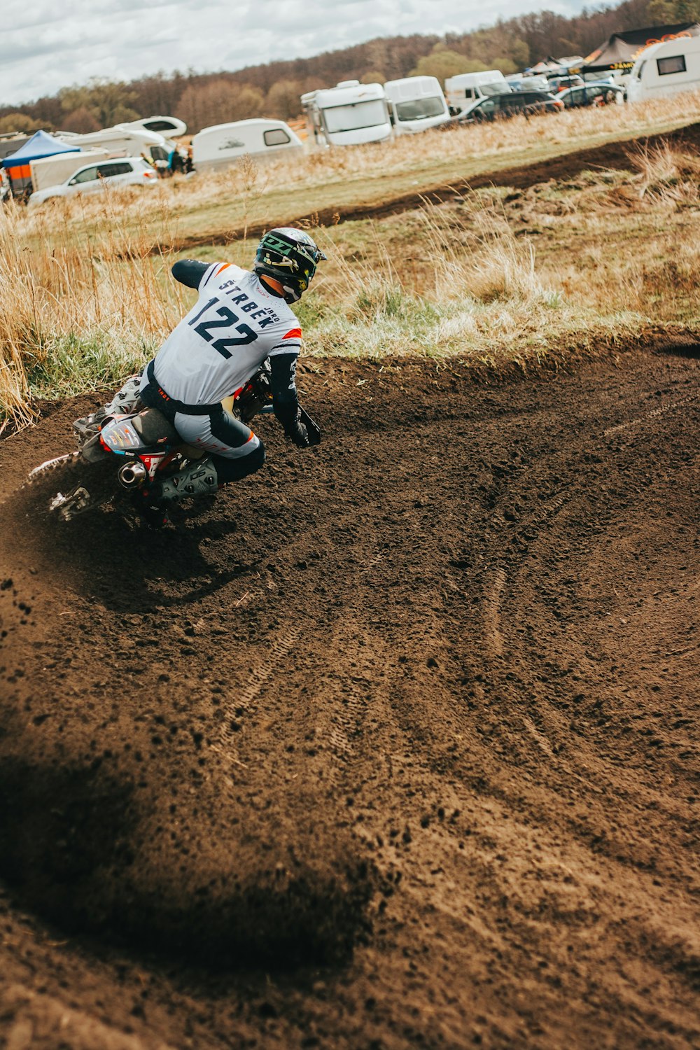 a person riding a dirt bike on a dirt track