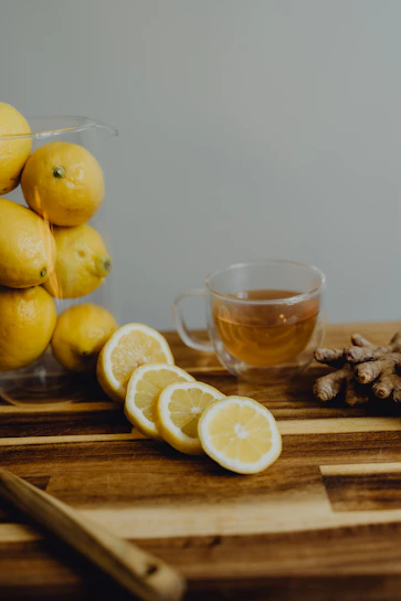 A serene kitchen scene with fresh fruits, herbs, and natural supplements arranged on a minimalist wooden table.
