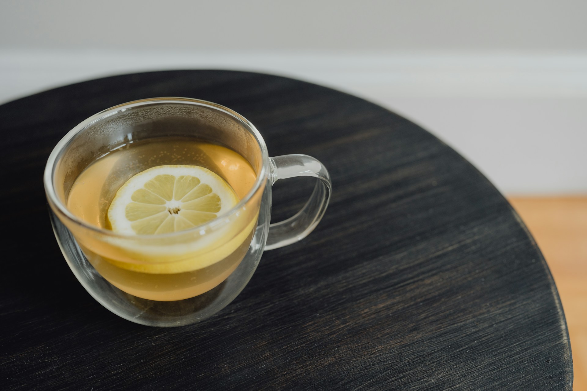 a cup of tea with a lemon slice in it