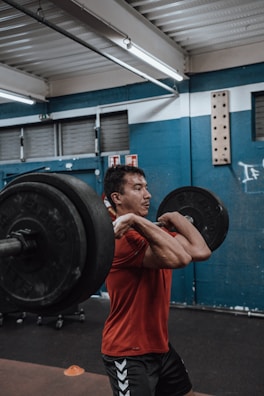 Athlete celebrating a personal best lift with a yellow contrast in the gym background.