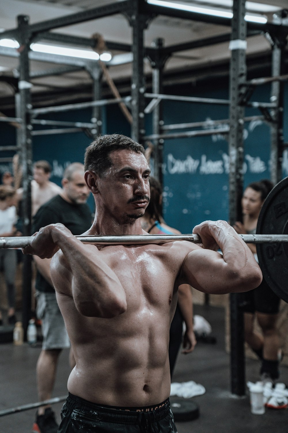 a man with a barbell in a gym