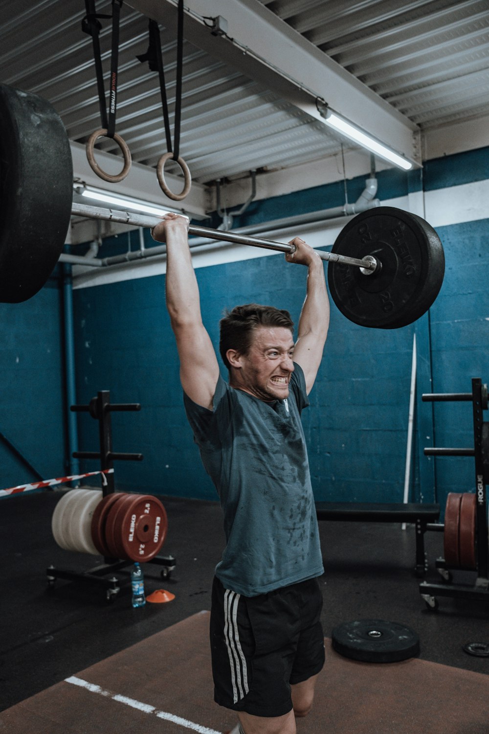 a man lifting a barbell in a gym