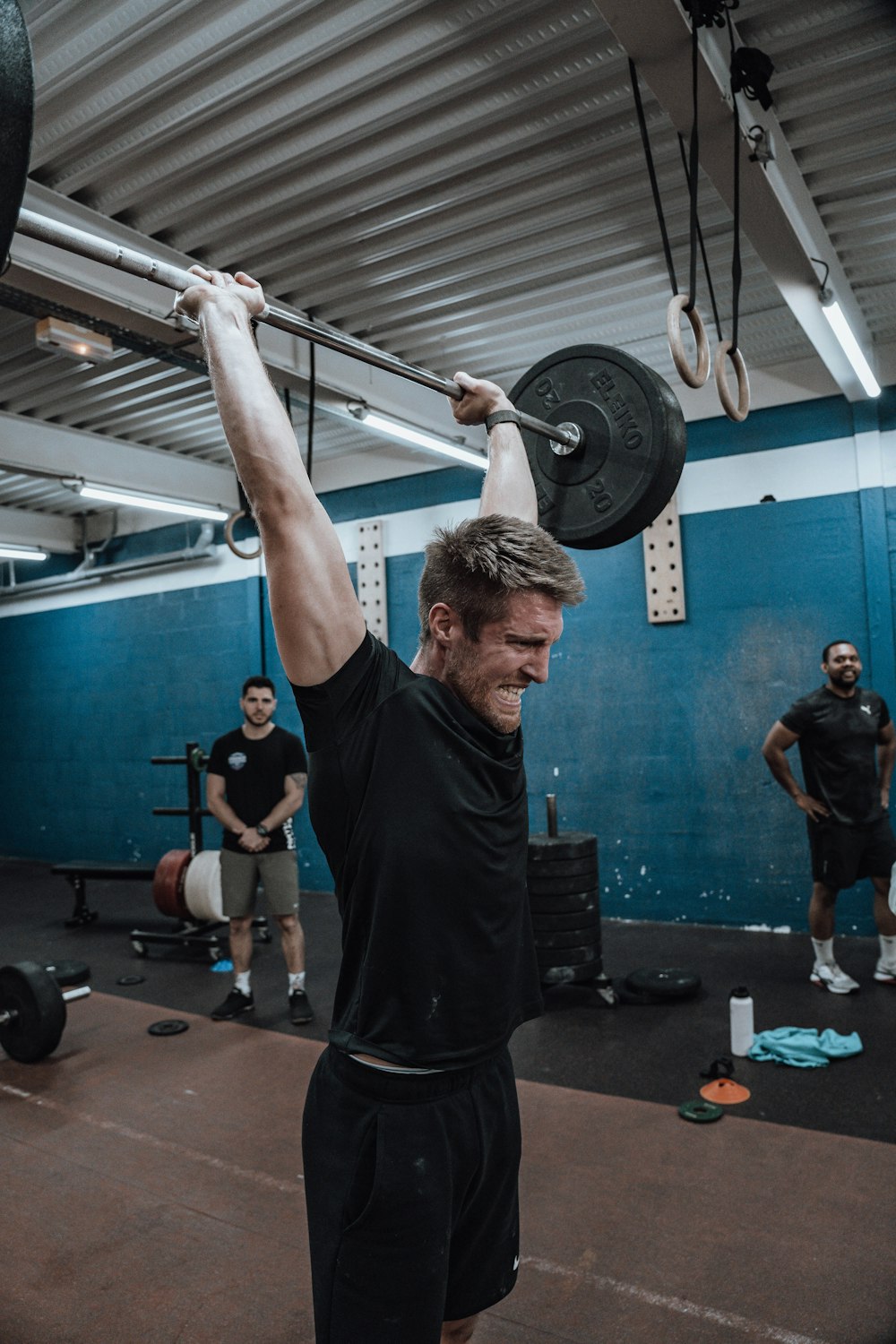 a man lifting a barbell in a gym