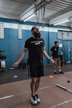 a man with a beard standing in a gym