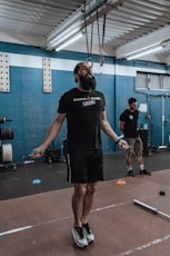 a man with a beard standing in a gym